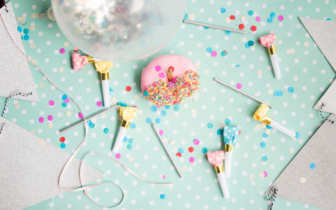 Party table scene with balloon, done and confetti