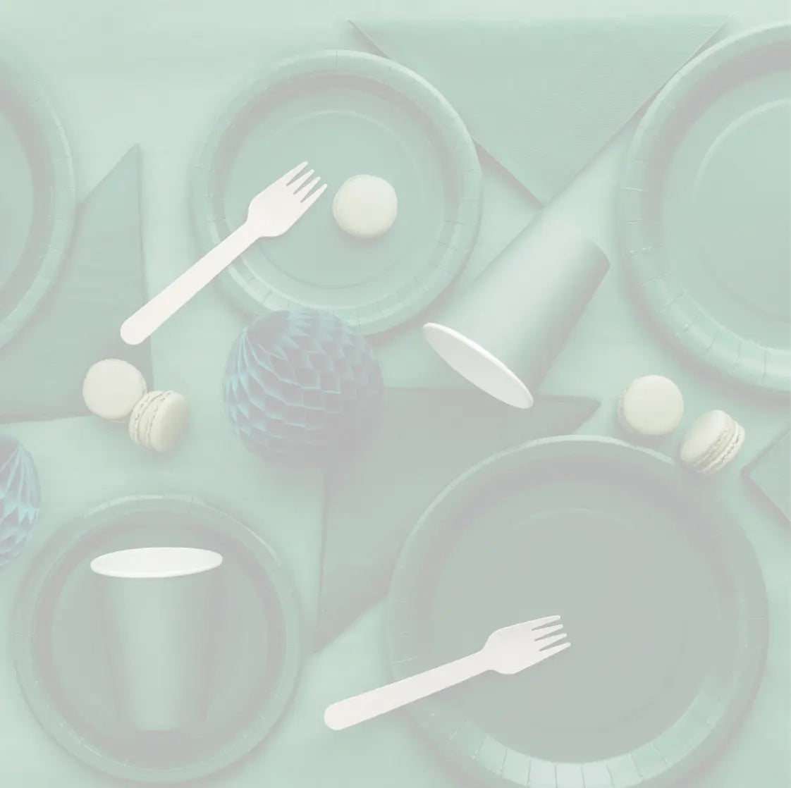 Flatlay of a green themed party table with green plates, green cups, bow napkins