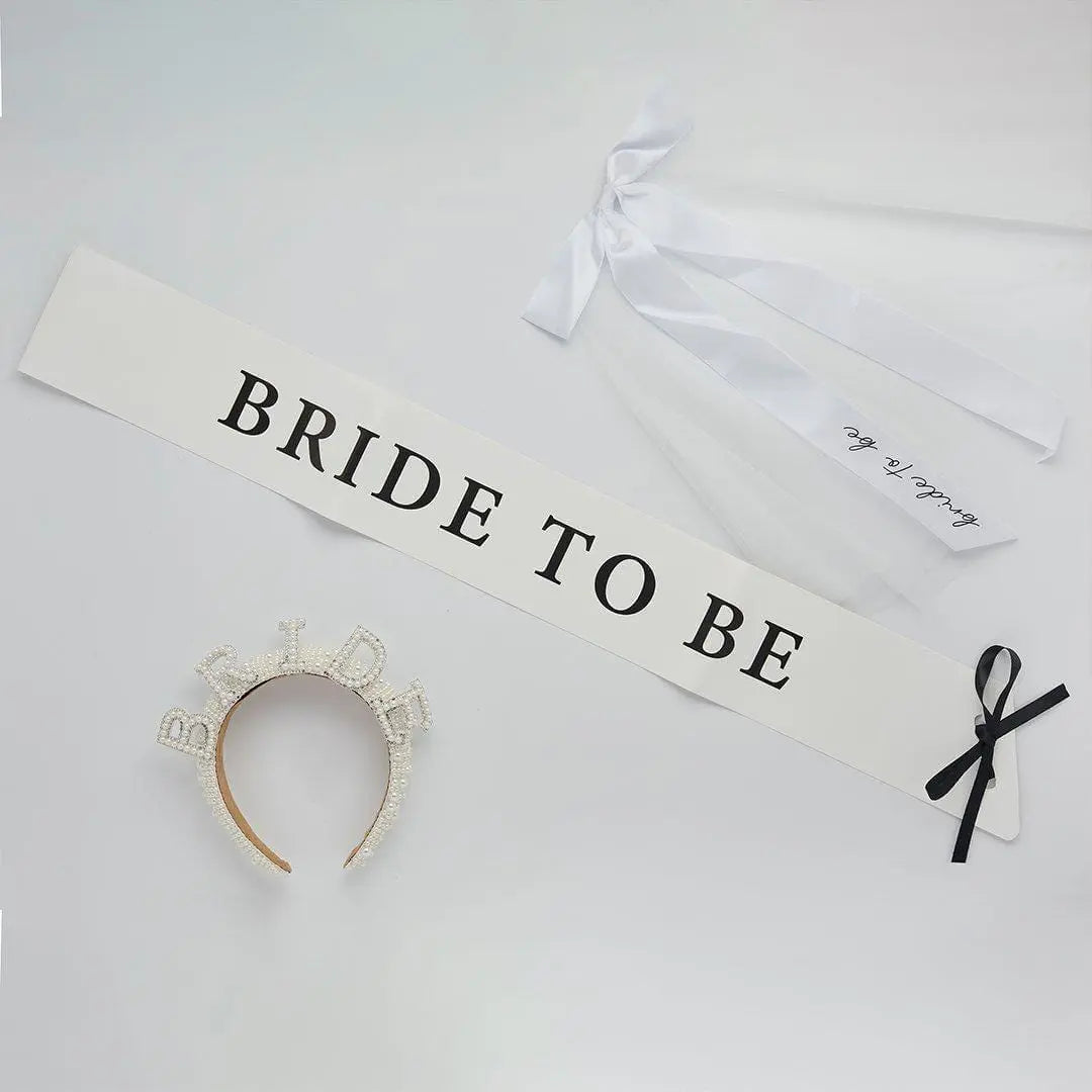 White Bride To Be Paper Sash - She’s Tying The Knot Hen Party Accessory - Coquette Bridal Shower Sash with Black Satin Ribbon - Hen Do Sash - Jolie Fete UK