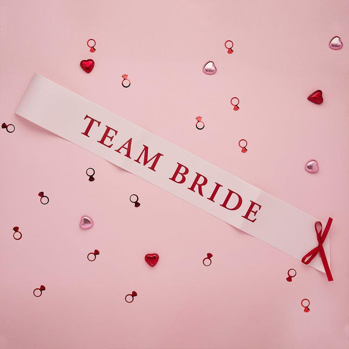 Pink & Red Team Bride Paper Sashes - She’s Tying The Knot Hen Party Accessories - Coquette Hen Do Sashes With Red Satin Ribbon - Pack of 5 - Jolie Fete UK