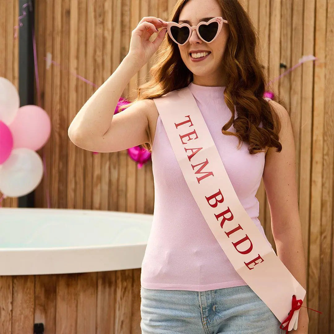 Pink & Red Team Bride Paper Sashes - She’s Tying The Knot Hen Party Accessories - Coquette Hen Do Sashes With Red Satin Ribbon - Pack of 5 - Jolie Fete UK