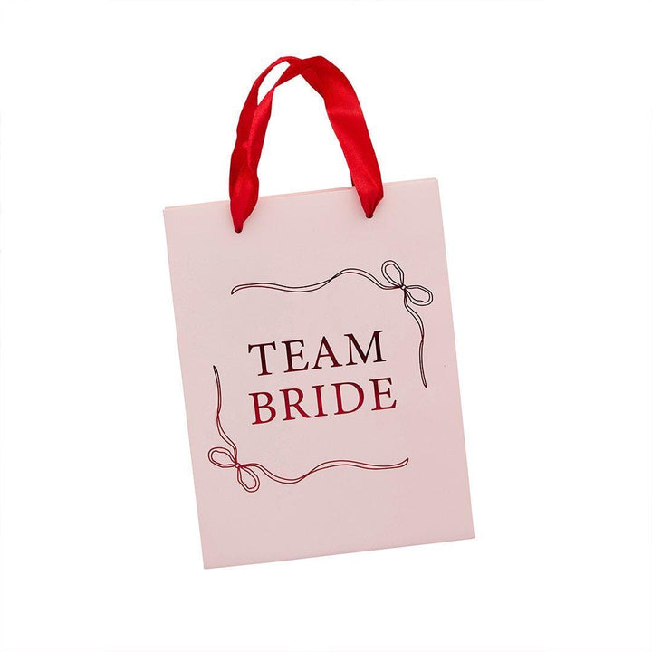 Team Bride Party Bags - Pink & Red She’s Tying The Knot Hen Do Gifts - Coquette Hen Party Gift Bags with Red Satin Handles - Pack of 5 - Jolie Fete UK